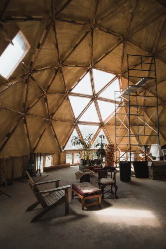 The geodesic dome (with a passive solar design) serves as the community gathering area. It is the future home of a shared kitchen and bathroom..